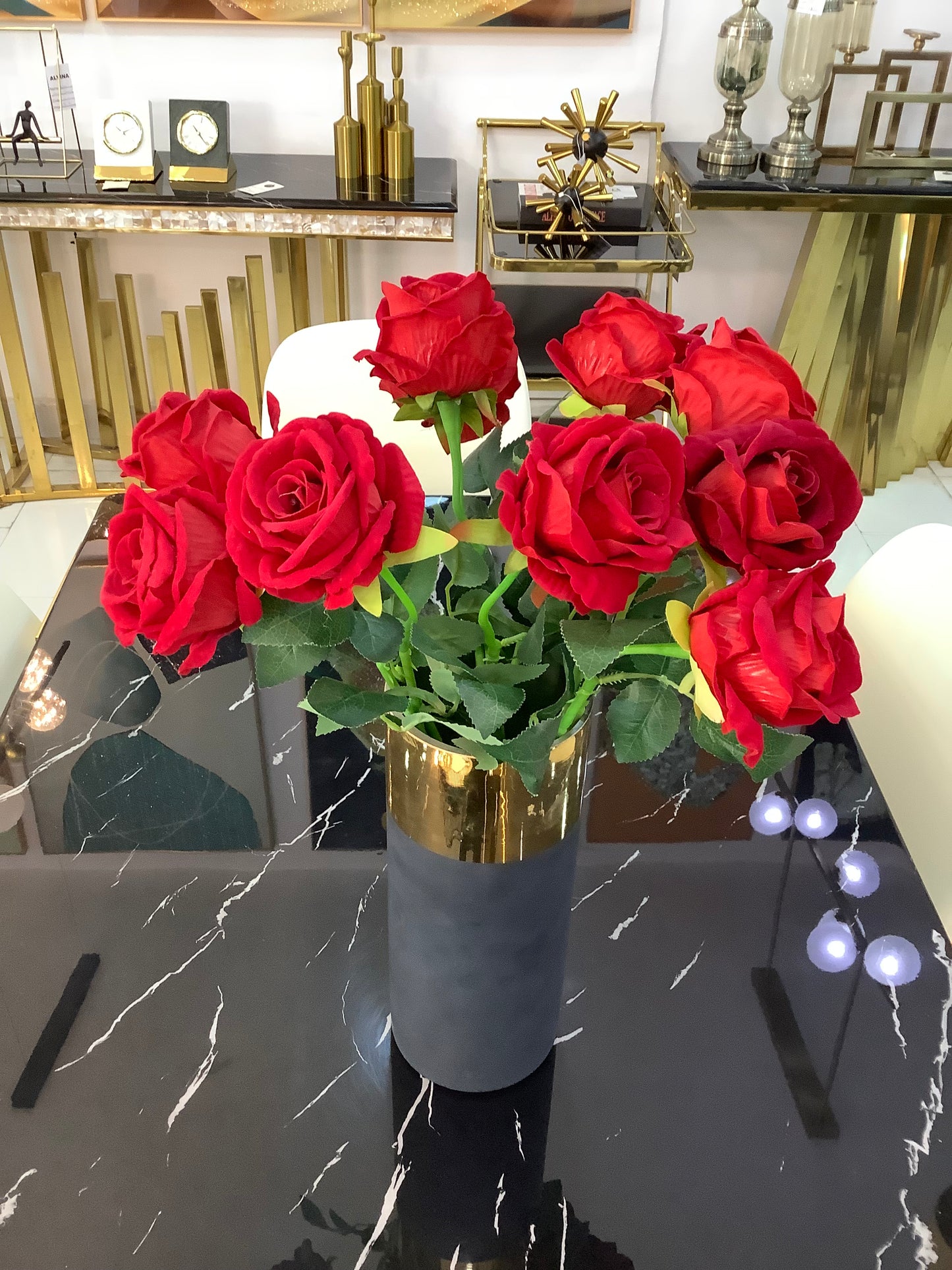 Black and gold vase with rose